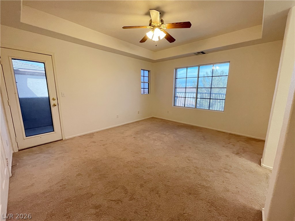 691 Principle Point Avenue Henderson, NV 89012 - Photo 18 of 30 Well-lit room featuring soft carpeting, a ceiling fan, and access to a private balcony.