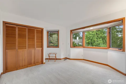 a view of a room with wooden floor and potted plant