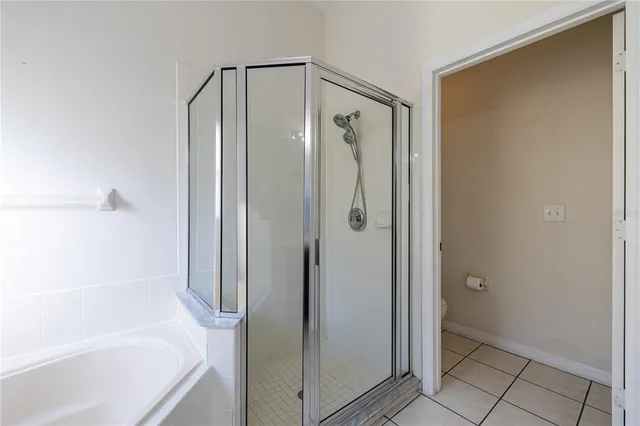 a bathroom with a sink a toilet a mirror and shower