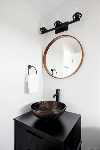 a bathroom with a sink and mirror