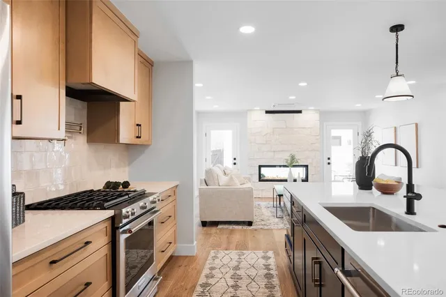 a kitchen with stainless steel appliances a stove sink and cabinets