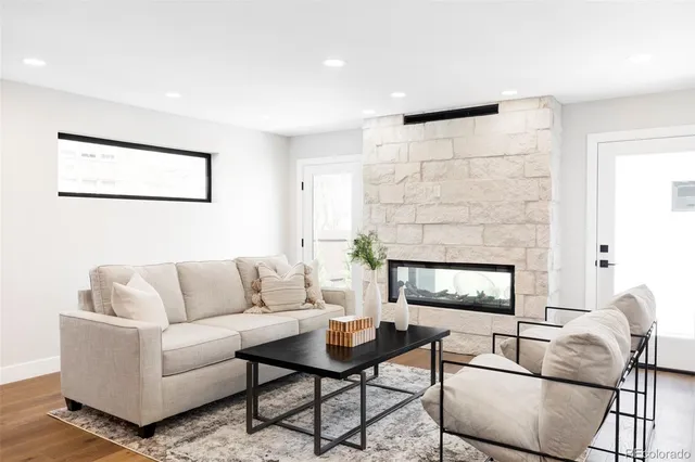 a living room with furniture and a fireplace