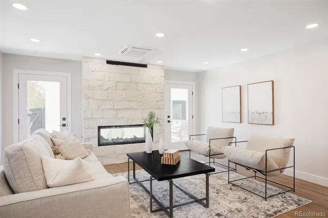 a living room with furniture and a fireplace