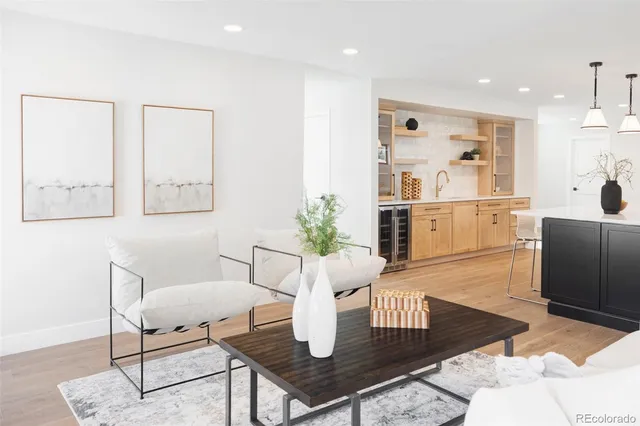 a living room with furniture potted plant and a table