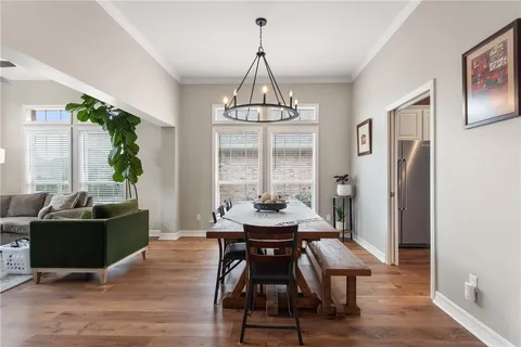 a dining room with furniture window and wooden floor