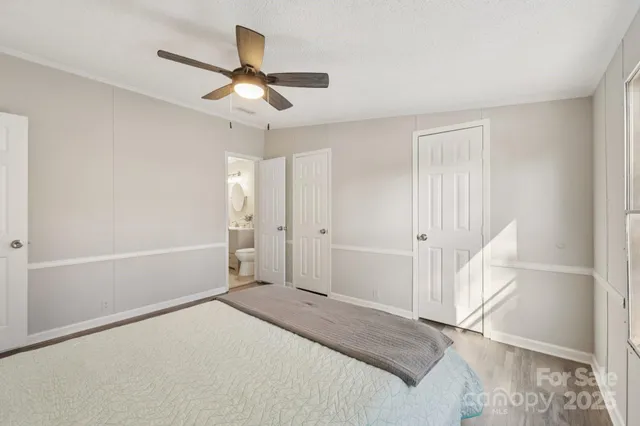 a bedroom with a bed and a ceiling fan