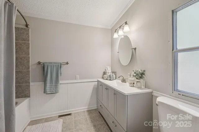 a bathroom with a sink vanity and mirror