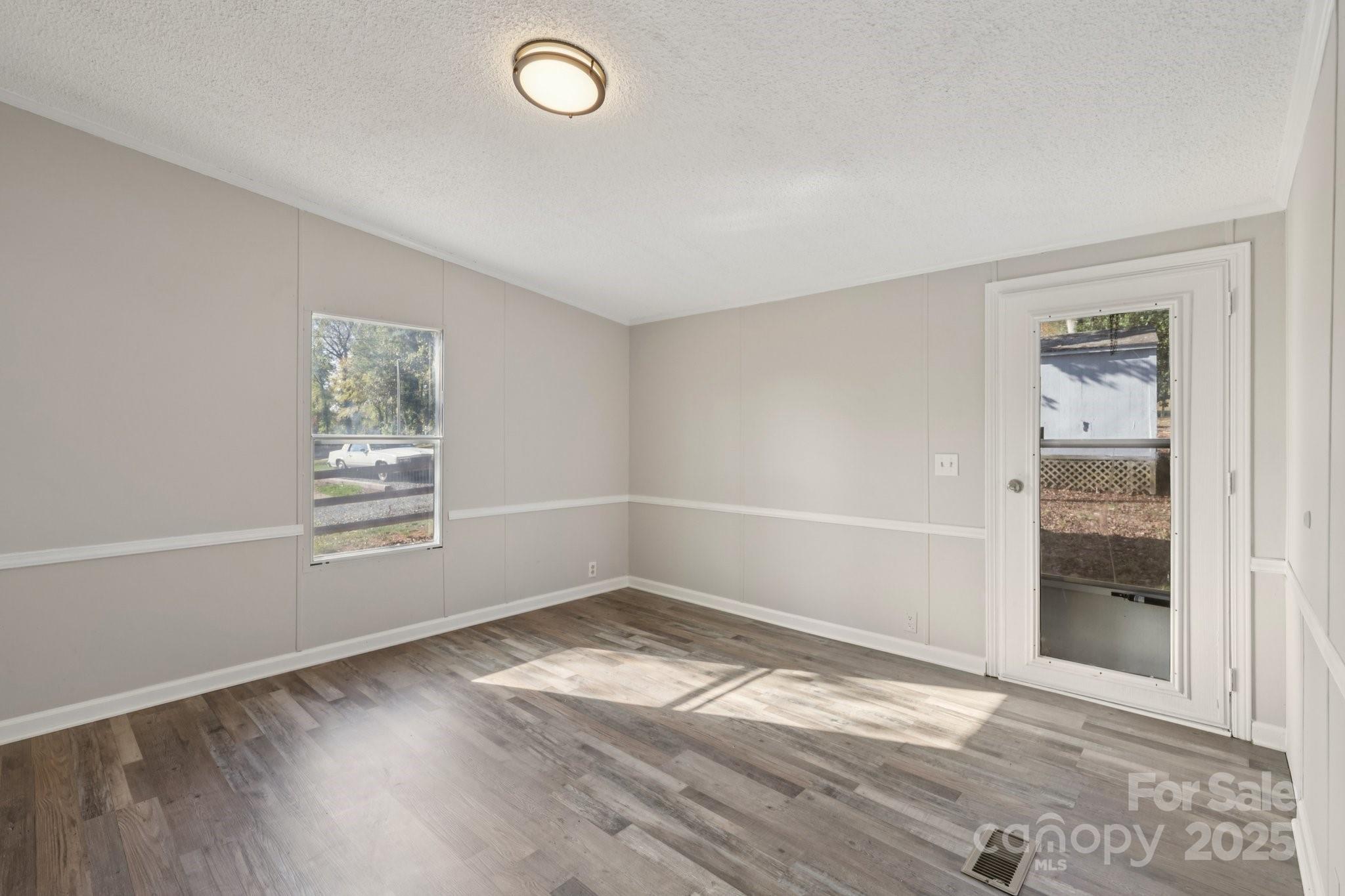1269 Eastcreek Road Fort Lawn, SC 29714 - Photo 22 of 44 an empty room with wooden floor and windows