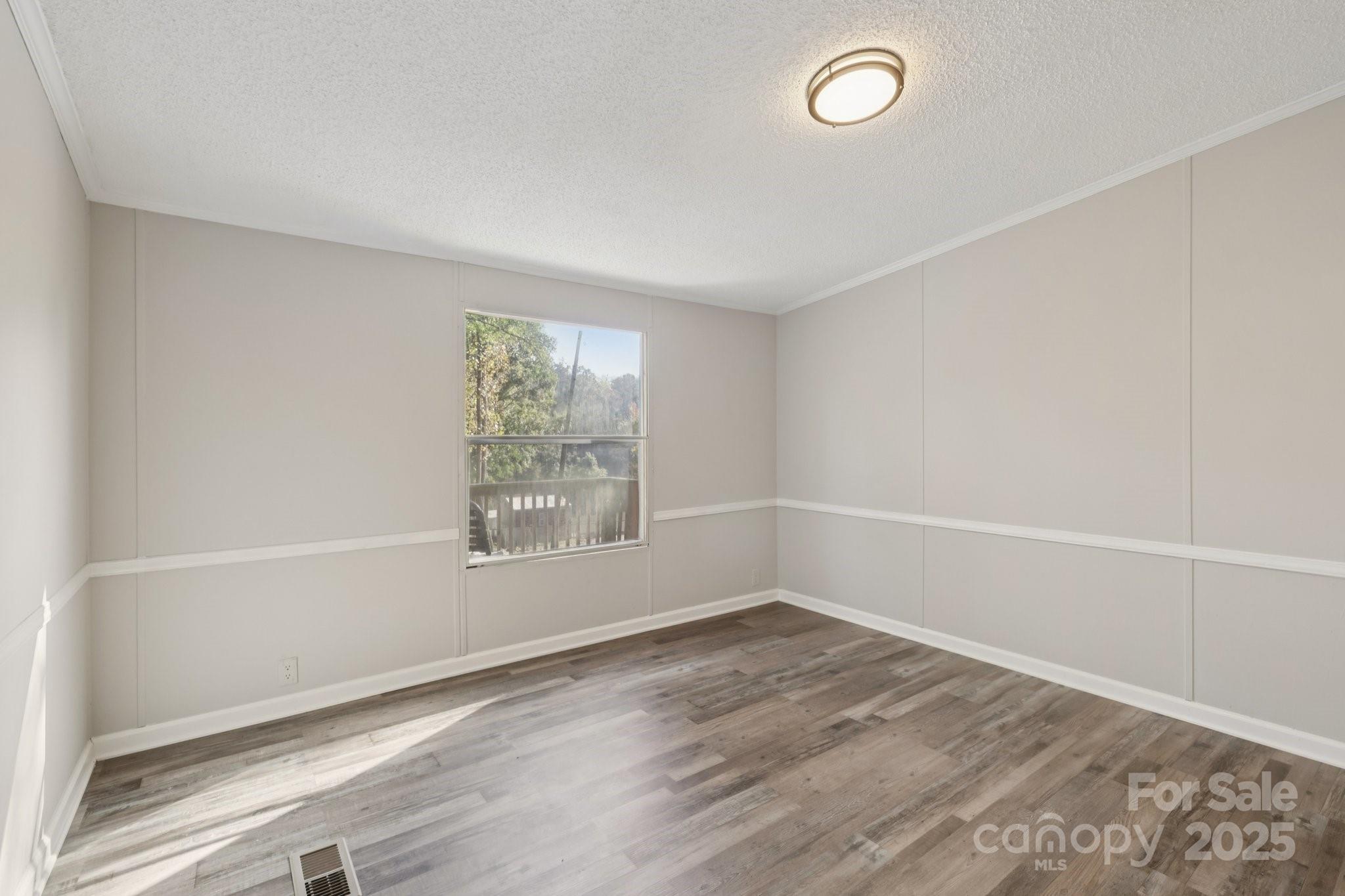 1269 Eastcreek Road Fort Lawn, SC 29714 - Photo 24 of 44 wooden floor in an empty room with a window