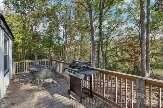 a view of a deck with a table and chairs with wooden fence and floor