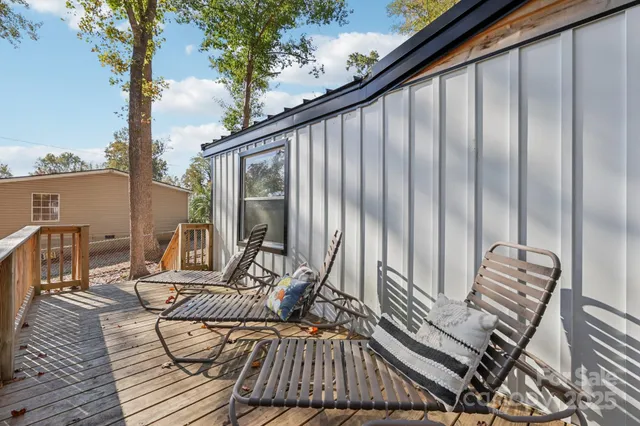a view of balcony with wooden floor and outdoor seating