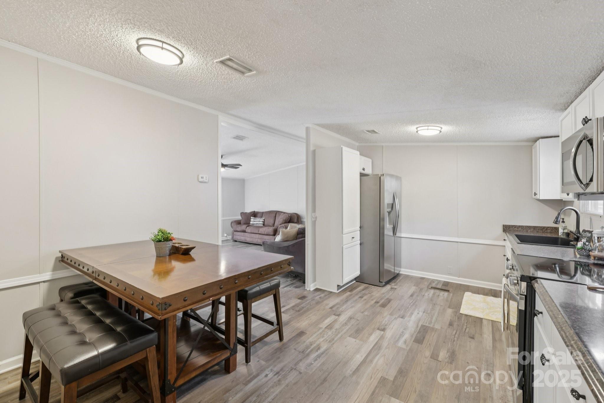 1269 Eastcreek Road Fort Lawn, SC 29714 - Photo 9 of 44 a view of a dining room with furniture and wooden floor