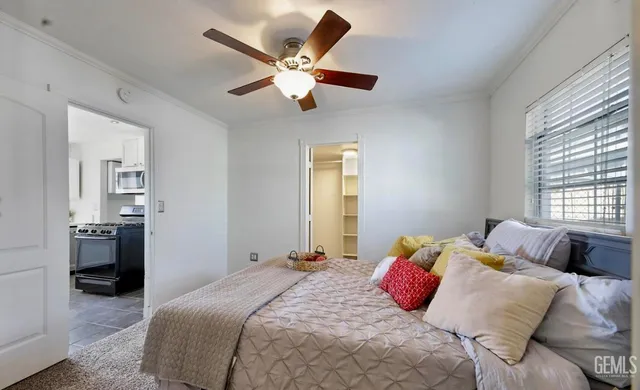 a bedroom with a large bed and a chandelier