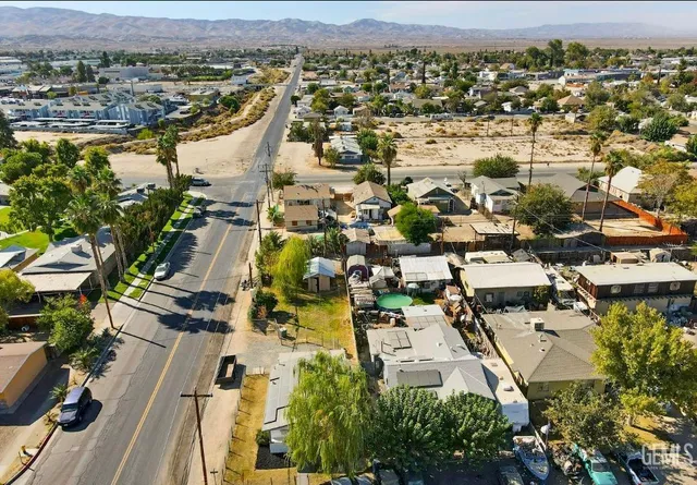 an aerial view of residential building with parking