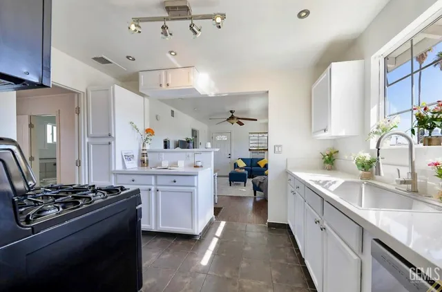 a kitchen with stainless steel appliances a sink stove and refrigerator