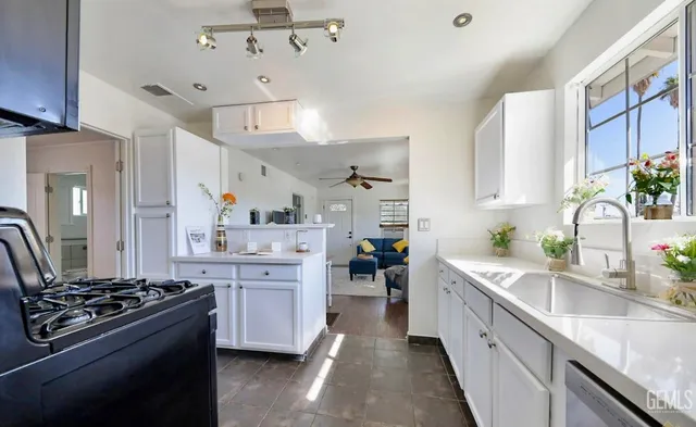 a kitchen with stainless steel appliances a sink stove and refrigerator