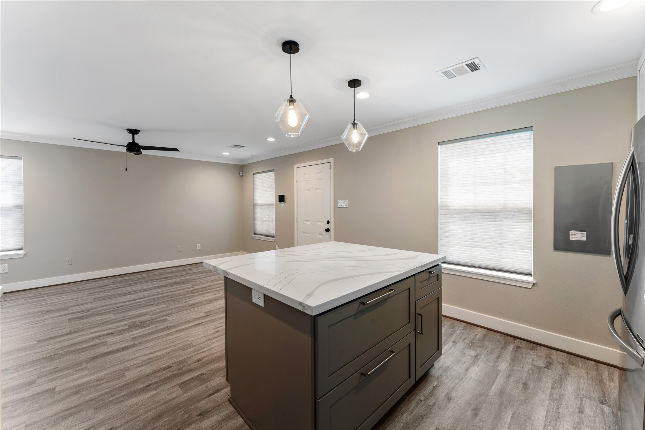 809 East 40th Street Houston, TX 77022 - Photo 9 of 27 Quartz countertops elevate the design, while the oversized island, updated lighting, and clean finishes make the space both functional and stylish. A built-in pantry with pull-out shelves adds smart, convenient storage.