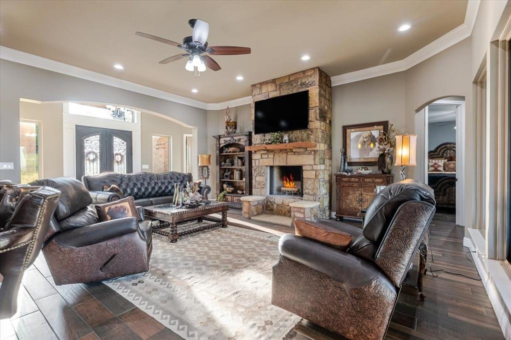 10106 Prather Road Springtown, TX 76082 - Photo 8 of 40 a living room with furniture a fireplace and a television