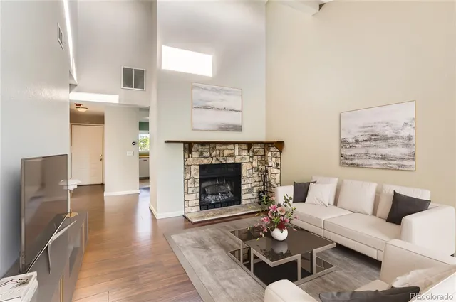 a living room with furniture and a fireplace