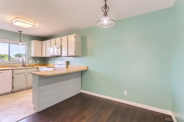 a room with a sink cabinets and window