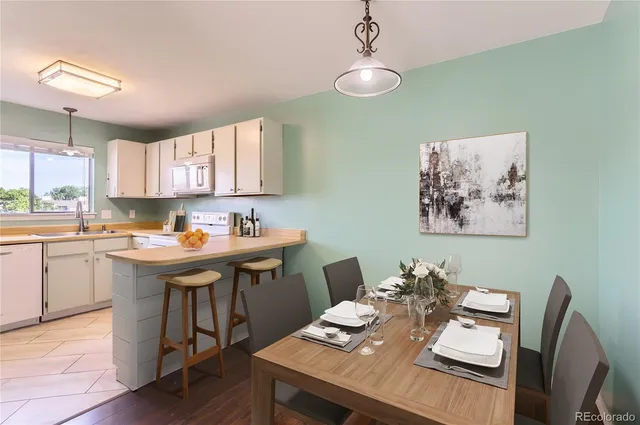 a view of a dining room with furniture and a window