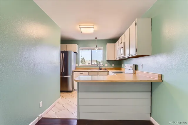 a kitchen with stainless steel appliances granite countertop a sink and a stove