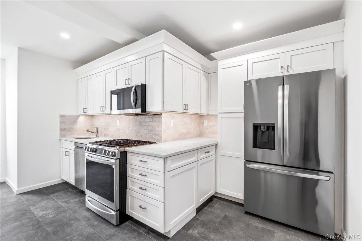 900 Palmer Road, Unit 10D Bronxville, NY 10708 - Photo 11 of 18 a kitchen with stainless steel appliances white cabinets and a granite counter tops