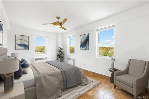 a bedroom with a bed couch and window