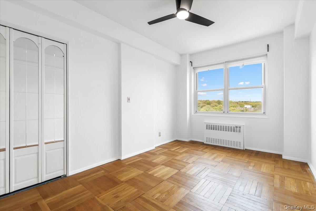 900 Palmer Road, Unit 10D Bronxville, NY 10708 - Photo 15 of 18 a view of an empty room with window and wooden floor