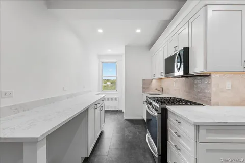 a kitchen with stainless steel appliances granite countertop a stove and a sink