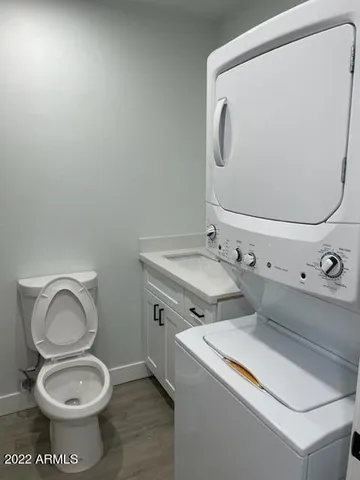 a bathroom with a toilet sink and mirror