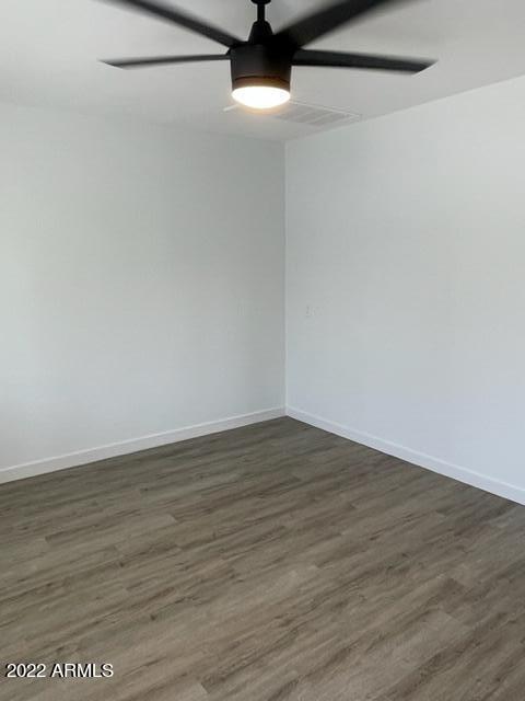 830 East Turney Avenue, Unit 9 Phoenix, AZ 85014 - Photo 18 of 28 a view of an empty room with wooden floor and a ceiling fan