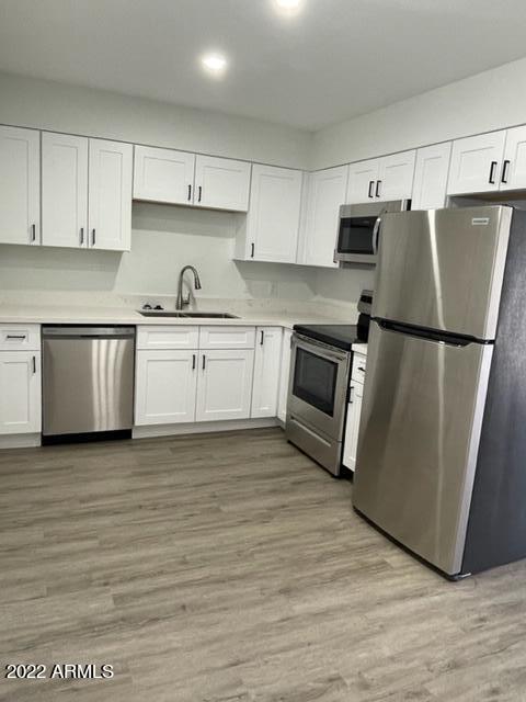 830 East Turney Avenue, Unit 9 Phoenix, AZ 85014 - Photo 8 of 28 a kitchen with granite countertop a refrigerator stove top oven and sink