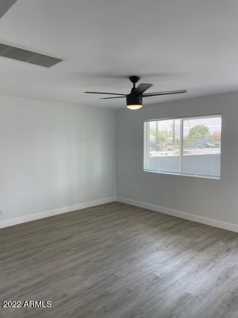 830 East Turney Avenue, Unit 9 Phoenix, AZ 85014 - Photo 9 of 28 wooden floor in an empty room with a window