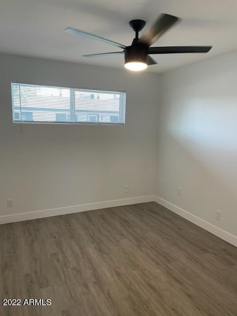 830 East Turney Avenue, Unit 9 Phoenix, AZ 85014 - Photo 10 of 28 a view of a room with wooden floor and a ceiling fan
