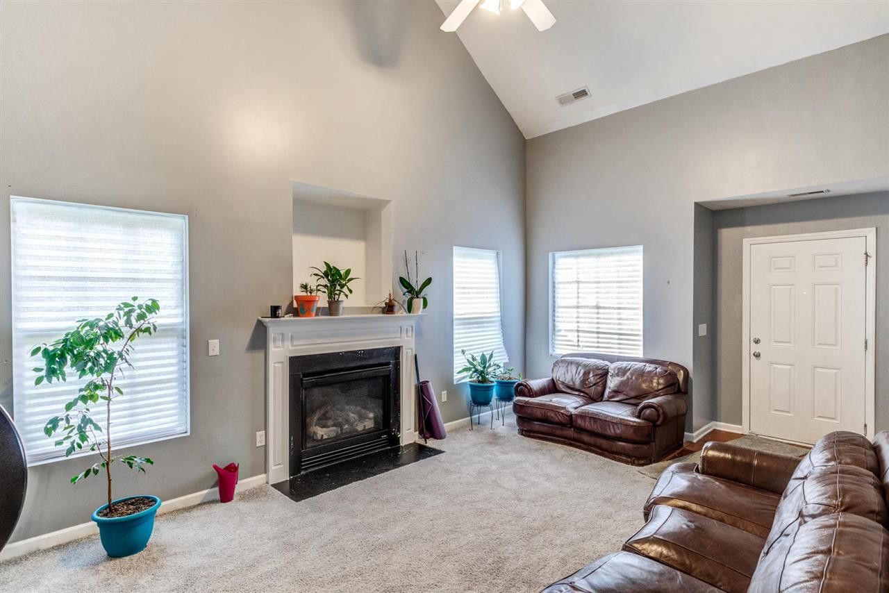 3713 Cyrus Street Raleigh, NC 27610 - Photo 6 of 30 Huge ceilings bring tons of light in the open Great room - complete with gas log fireplace Den/Family/Great Room
