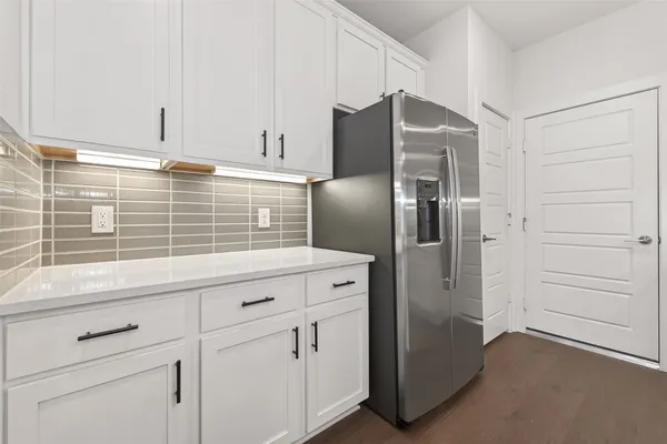 a kitchen with appliances cabinets and a counter top space