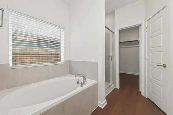 a bathroom with a bathtub and a shower