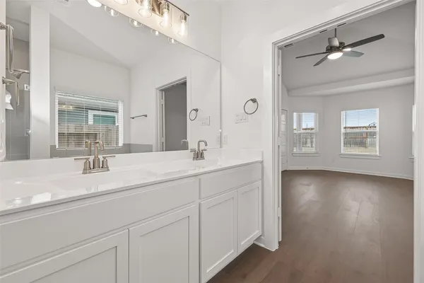 a bathroom with a double vanity sink and a mirror