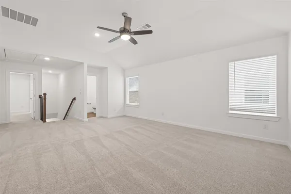 a view of a livingroom with a ceiling fan and window