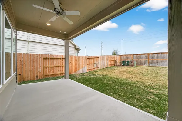a view of an house with backyard space and balcony