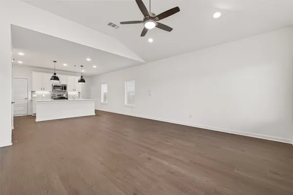 a view of a livingroom with furniture a ceiling fan and window