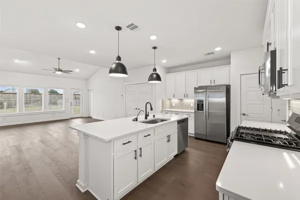 a kitchen with refrigerator and cabinets
