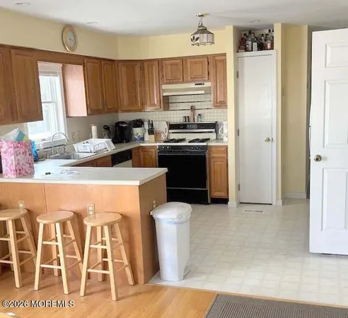 a kitchen with stainless steel appliances a stove a sink and a refrigerator