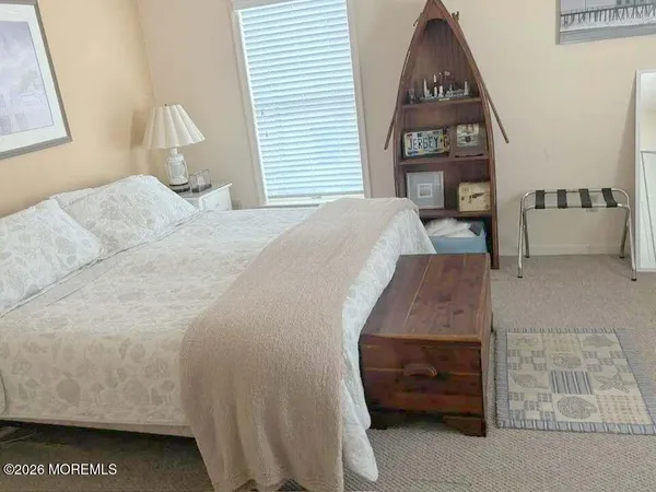 a spacious bedroom with a bed and a window