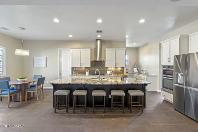 a large kitchen with a table and chairs