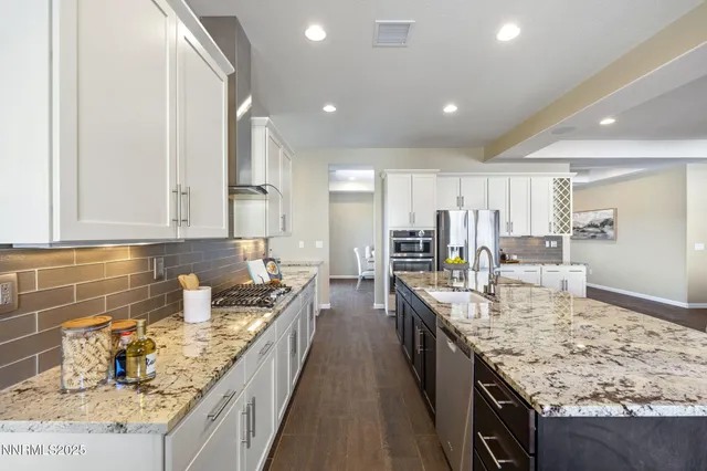 a large kitchen with stainless steel appliances granite countertop plenty wooden cabinets
