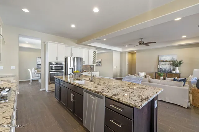 a kitchen with center island and stainless steel appliances