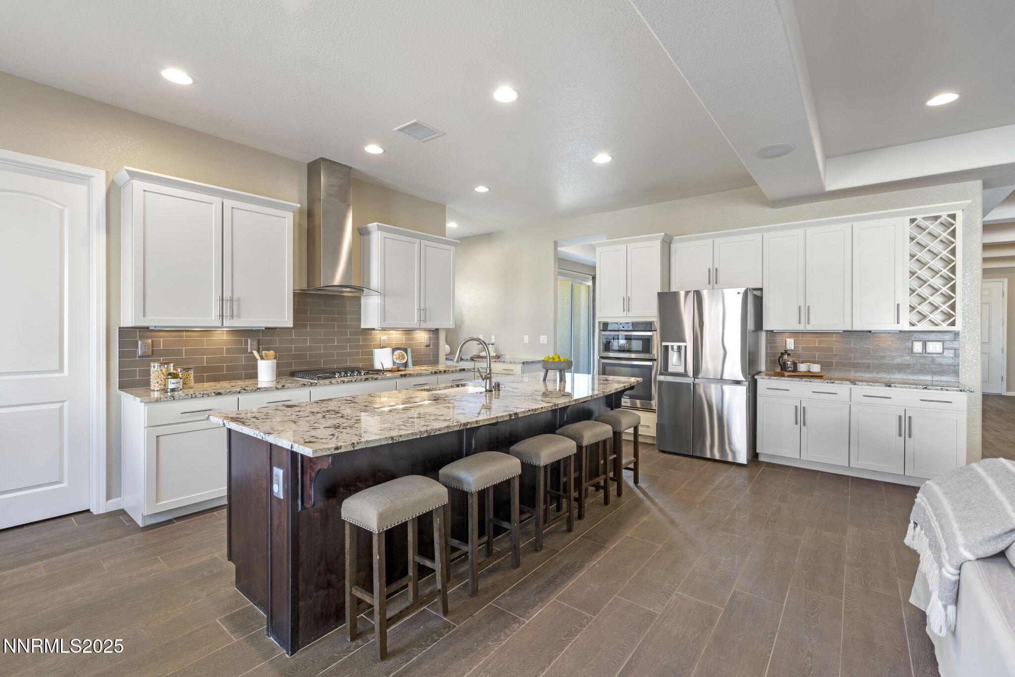 1755 Back Nine Trail Reno, NV 89523 - Photo 16 of 49 a kitchen with stainless steel appliances granite countertop a table chairs sink refrigerator and cabinets