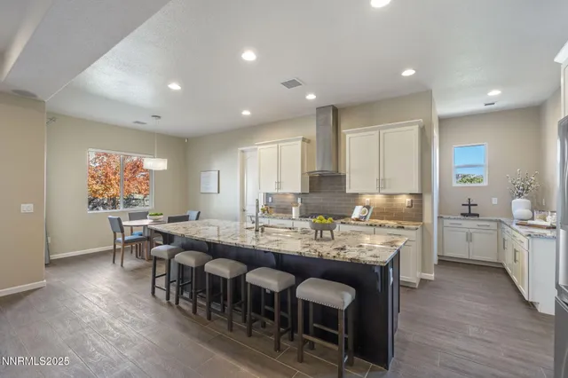a large kitchen with a table and chairs